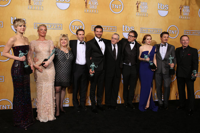 From left, Jennifer Lawrence, Elisabeth Rohm, Colleen Camp, Alessandro Nivola, Bradley Cooper, Robert De Niro, David O. Russell, Amy Adams, Jeremy Renner and Paul Herman pose in the press room with the award for outstanding performance by a cast in a motion picture for “American Hustle” at the 20th annual Screen Actors Guild Awards at the Shrine Auditorium on Saturday, Jan. 18, 2014, in Los Angeles. (Photo by Matt Sayles/Invision/AP)