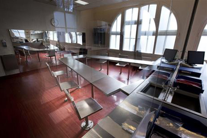 Surveillance cameras, right, are mounted underneath a metal table with chairs bolted to the floor where addicts can inhale heroin fumes in a clinic in Amsterdam, Netherlands, Tuesday, April 12, 2016. An alarming 47,000 American overdose deaths in 2014 _ 60 percent from heroin and related opioid painkillers like fentanyl _ has pushed elected leaders in New York, California and other states to consider what was once unthinkable: government-sanctioned sites where users are under the supervision of a doctor or nurse who can administer an antidote if necessary. (AP Photo/Peter Dejong)
