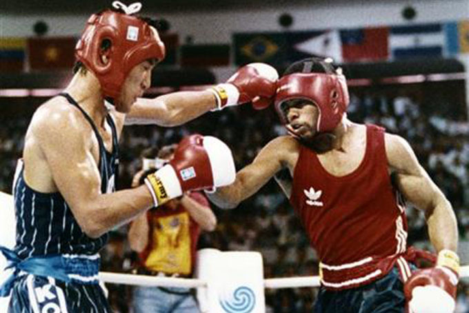 In this Oct. 2, 1988, file photo, South Korea's Park Si-hun, left, delivers a left jab to America's Roy Jones, and goes on to win the gold medal in the gold medal bout of the light middleweight division at the summer Olympics in Seoul, South Korea. (AP Photo/Ron Kutz, File)