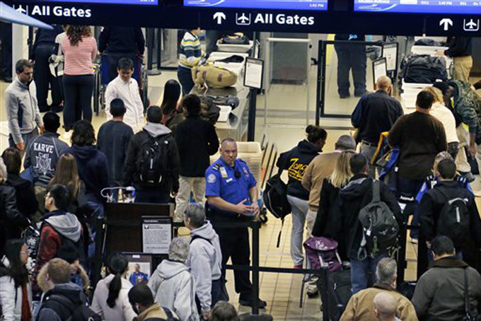 Holiday travelers wait in the security line at Pittsburgh International Airport in Imperial, Pa., on Tuesday afternoon, Nov. 26. (AP Photo/Gene J. Puskar)
