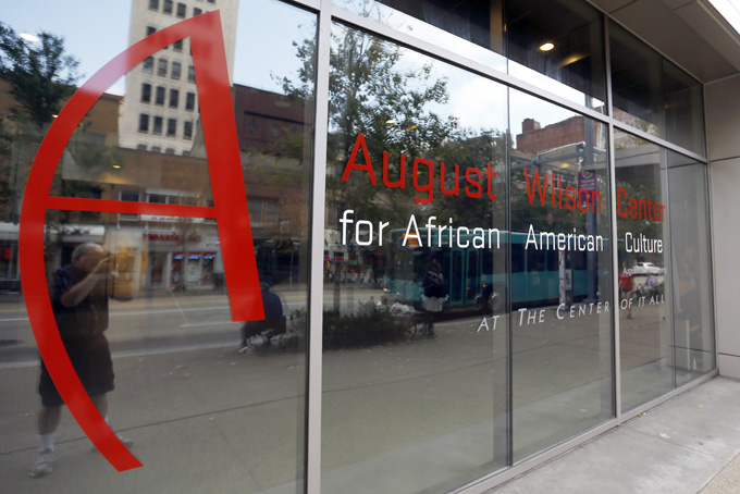 Buildings in downtown Pittsburgh are reflected in the windows of the August Wilson Center for African American Culture on Oct. 2. (AP Photo/Keith Srakocic)