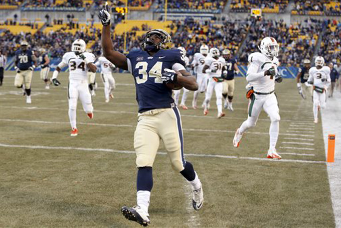 Pittsburgh running back Isaac Bennett (34) celebrates as he runs past the Miami defense for a touchdown in the first quarter of an NCAA college football game in Pittsburgh on Friday, Nov. 29, 2013. (AP Photo/Keith Srakocic)
