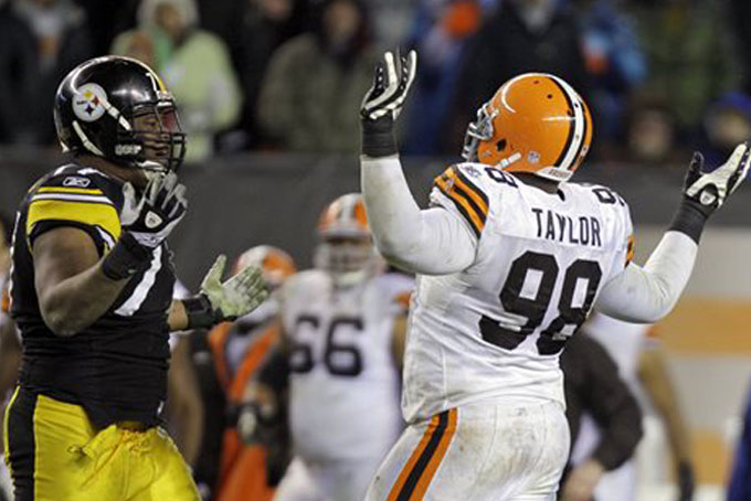 In this Jan. 1, 2012 file photo, Pittsburgh Steelers offensive tackle Marcus Gilbert, left, and Cleveland Browns defensive tackle Phillip Taylor (98) argue after a fumble in the fourth quarter of an NFL football game in Cleveland. (AP Photo/Mark Duncan, File)