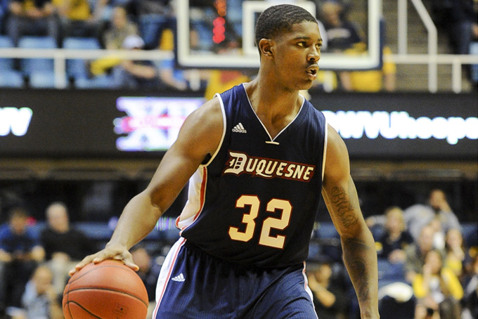 Duquesne's Desmond Ridenour (32) brings the ball up the court during the second half of an NCAA college basketball game against West Virginia, Sunday, Nov. 17, 2013, in Morgantown, W.Va. West Virginia won 96-83. (AP Photo/Andrew Ferguson)