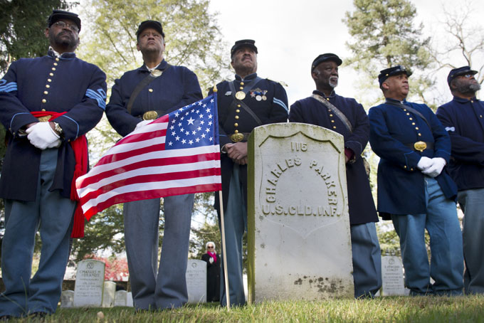 Civil War re-enactors from the 3rd and 54th Massachusetts Volunteer Infantry Regiment Company B stand by the grave of soldier Charles Parker during a graveside salute to the veterans of the United States colored troops at Soldiers' National Cemetery Tuesday, Nov. 19, 2013. in Gettysburg, Pa. (AP Photo/York Daily Record, Paul Kuehnel) 