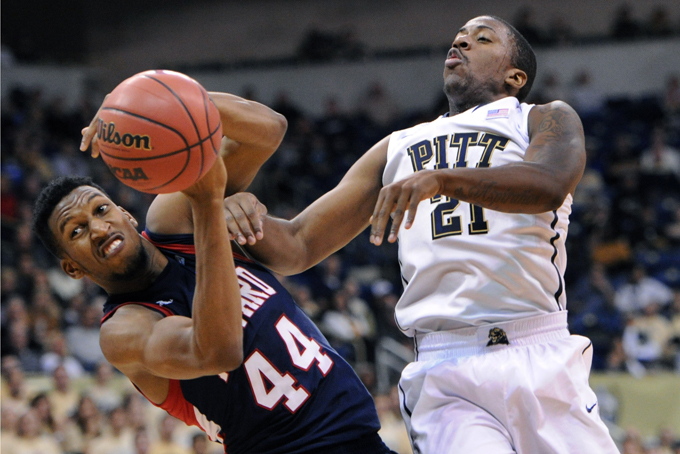 Howard's Oliver Ellison, left, and Pittsburgh's Lamar Patterson, right, fight for possession in the first half of an NCAA college basketball game on Sunday, Nov. 17, 2013, in Pittsburgh. (AP Photo/John Heller)