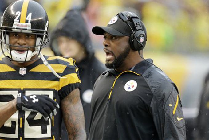 Mike Tomlin talks with cornerback Ike Taylor (24) during the first half of an NFL football game against the Detroit Lions in Pittsburgh, Nov. 17. (AP Photo/Gene J. Puskar)