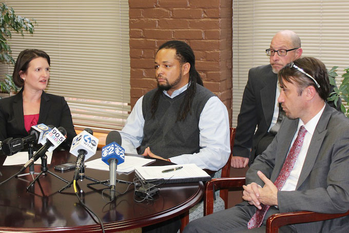Teacher Dennis Henderson, joined by attorneys, from left to right: Sara Rose, James Love and Glen Downey, announces his federal lawsuit against Pittsburgh Police Officer Jonathan Gromeck for a wrongful arrest in Homewood in June. (Courier Photo by J.L.Martello)