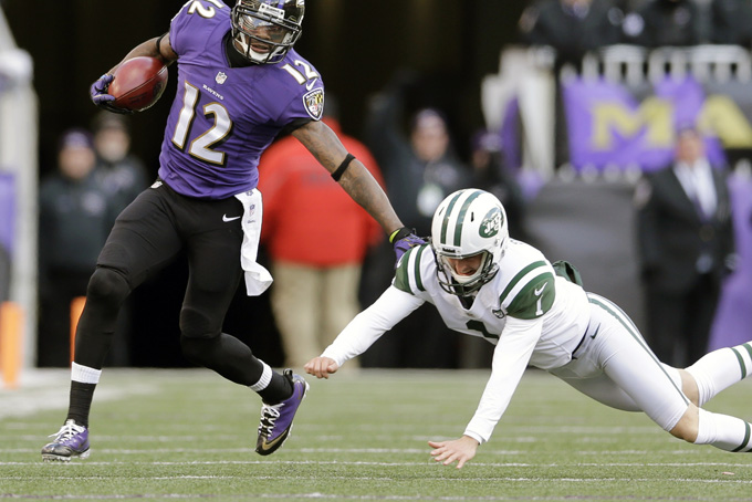 Jacoby Jones out runs New York Jets punter Ryan Quigley on a punt return in Baltimore, Nov. 24. The Baltimore Ravens receiver and former 'Dancing With the Stars' performer accounted for 249 yards and scored the game's lone touchdown in a 19-3 win over the New York Jets.(AP Photo/Patrick Semansky)  