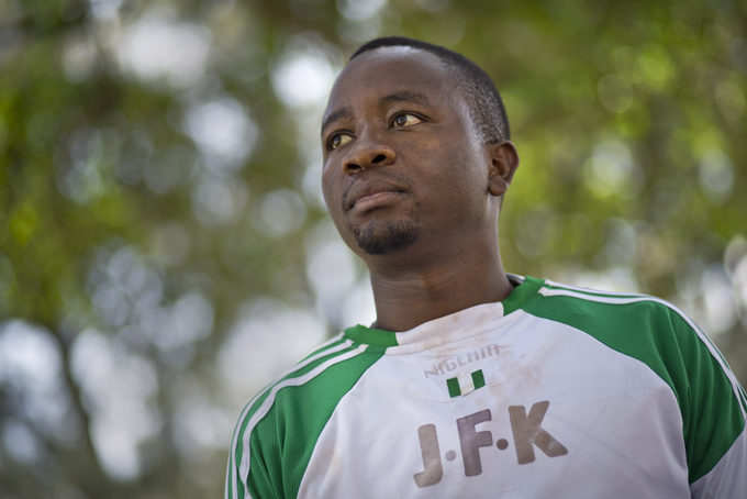John Fitzgerald Kennedy Munene, a 32-year-old Kenyan whose mother chose that name when she gave birth to him in the U.S. while on a student exchange program, stands for a photograph wearing the goalkeeper's shirt emblazoned with the initials "JFK" that he uses to play amateur soccer, in downtown Nairobi, Kenya on Friday, Nov. 15, 2013.  (AP Photo/Ben Curtis)