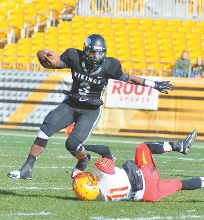 LENNY WILLIAMS (3) Sto Rox quarterback is tripped up by Timon Gribbin of Cardinal Wuerl North Catholic in the WPIAL Class A championship game, Williams, a Temple recruit finished his outstanding high school career with 11,559 offensive yards (the most in WPIAL history)  and 102 touchdowns.