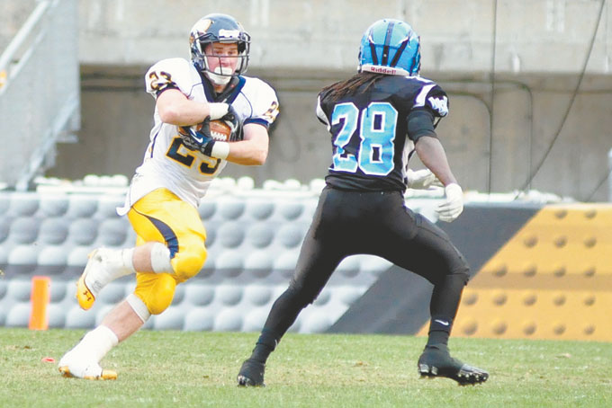 LLUIGI LISTA-BRINZA (23) of Central Catholic slogs thru the mud and snow at Heinz Field , Lista-Brinza, the Vikings workhorse running back rushed 27 times for 136 yards and 2 touchdowns in the Vikings 27-7 win over Woodland Hills in the WPIAL Class AAAA championship game.