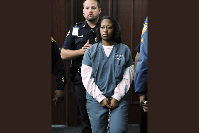 Marissa Alexander enters the courtroom for her bond hearing Wednesday, Nov. 13, 2013, in Jacksonville, Fla. Alexander is getting a new trial after a court overturned her 20-year prison sentence for firing what she called a warning shot at her husband. Her case has drawn attention and criticism aimed at mandatory-minimum sentencing laws. (AP Photo/The Florida Times-Union/Bob Self)