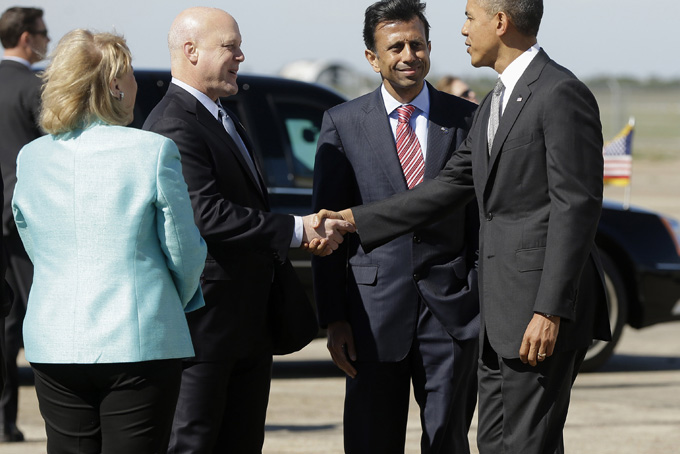 President Barack Obama is greeted by Gov. Bobby Jindal, center, and New Orleans Mayor Mayor Mitchell Landrieu, on the tarmac upon his arrival on Air Force One at Louis Armstrong International Airport, Friday, Nov. 8, 2013. At left is Sen. Mary Landrieu, D-La. who traveled from Washington with the president. (AP Photo/Pablo Martinez Monsivais)