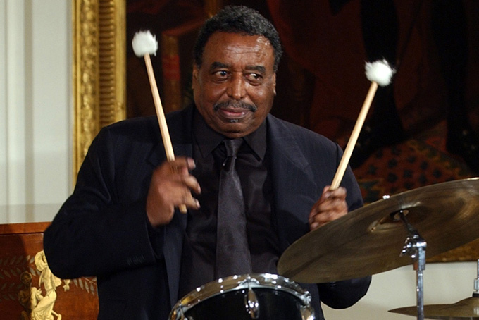 This June 22, 2004 file photo shows Chico Hamilton, a recipient of the he National Endowment for the Arts Jazz Masters Fellowship, performing a drum solo in the East Room of the White House during a reception to honor Black Music Month, in Washington. (AP Photo/Susan Walsh)