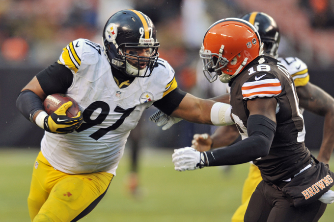 Pittsburgh Steelers defensive end Cameron Heyward (97) fends off Cleveland Browns wide receiver Greg Little after a fumble recovery in the fourth quarter of an NFL football game on Sunday, Nov. 24, 2013. (AP Photo/David Richard)