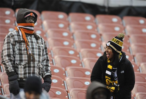 A Pittsburgh Steelers fan laughs beside a Cleveland Browns fan in the fourth quarter of an NFL football game Sunday, Nov. 24, 2013. Pittsburgh won 27-11. (AP Photo/David Richard)