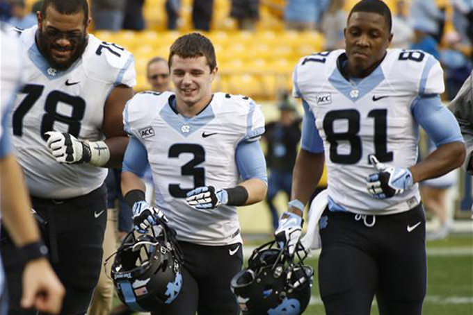 North Carolina freshman punt returner Ryan Switzer (3) smiles as he trots off the field with guard Landon Turner (78) and wide receiver Roy Smith (81) after an NCAA football game against Pittsburgh on Saturday, Nov. 16, 2013 in Pittsburgh. Switzer returned two punts for touchdowns in North Carolina's 34-27 win.(AP Photo/Keith Srakocic)