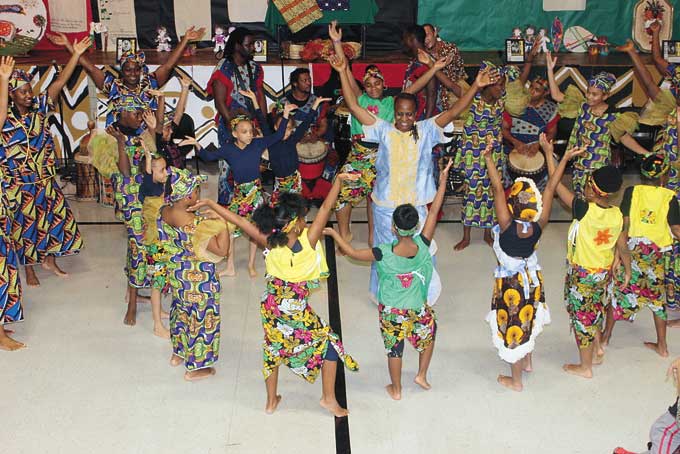 KUUMBA—Creativity, one of the seven pillars of African Heritage, is demonstrated during a performance by the BALAFON West African Dance Ensemble at CEA’s Kwanzaa celebration on Dec. 28. (Photo by J.L. Martello)