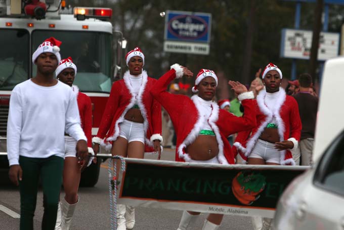 The Prancing Elites, an all male dance team, performs in the Semmes Christmas parade on Saturday, Dec. 21, 2013. (AP Photo/Mobile Press-Register, Sharon Steinmann)
