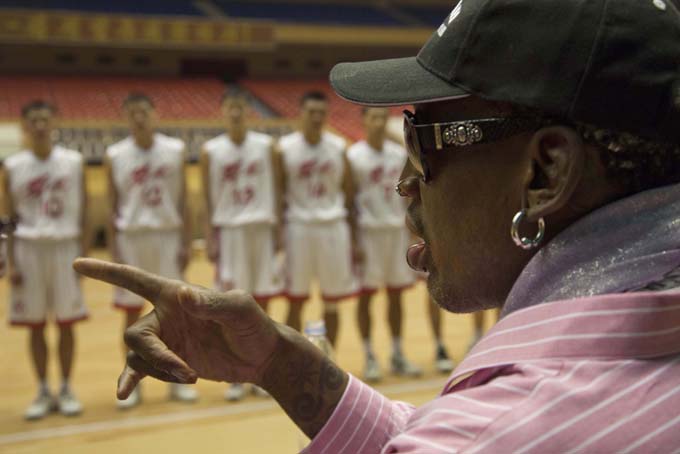 Former NBA basketball star Dennis Rodman speaks to North Korean basketball players during a practice session in Pyongyang, North Korea on Friday, Dec. 20, 2013. (AP Photo/David Guttenfelder)