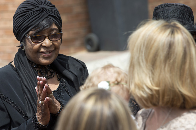 Winnie Madikizela-Mandela, left, Nelson Mandela's former wife, greets worshippers at the Bryanston Methodist Church in Bryanston suburb of Johannesburg, South Africa, Sunday Dec. 8, 2013.(AP Photo/Peter Dejong)