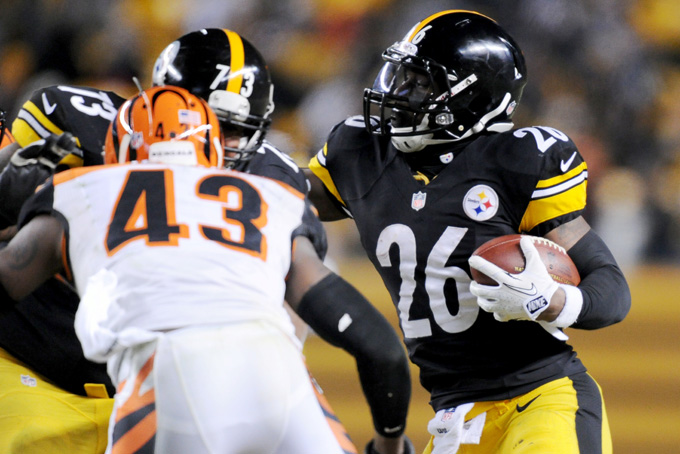 Running back Le'Veon Bell (26) runs towards Cincinnati Bengals strong safety George Iloka (43) in the third quarter of an NFL football game on Sunday, Dec. 15, 2013, in Pittsburgh. (AP Photo/Don Wright)