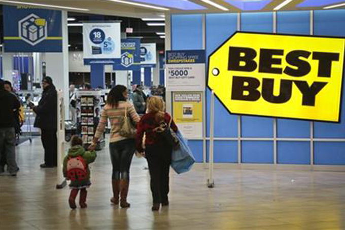 In this Nov. 23, 2013, file photo, shoppers enter a Best Buy in New York. (AP Photo/Bebeto Matthews, File)