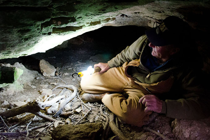 Nolen Boone's family has owned his 120-acre farm in New Haven, Ky., for generations. Boone crawls around a cave that spiders for a mile under his property and that of two of his neighbors. (Photo by Natasha Khan / PublicSource)