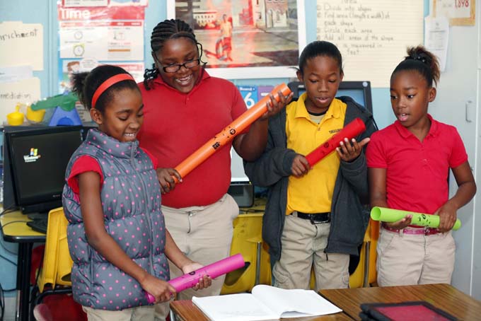 In this Dec. 16 photograph, Tunica Elementary School fourth graders from left, Alysia Ware, Kendrenesha Pollard, Brian Franklin and Elajah Davis, sing their jointly composed blues song while keeping time with their Boom Whackers, a form of rhythm sticks, in their class in Tunica, Miss. (AP Photo/Rogelio V. Solis)