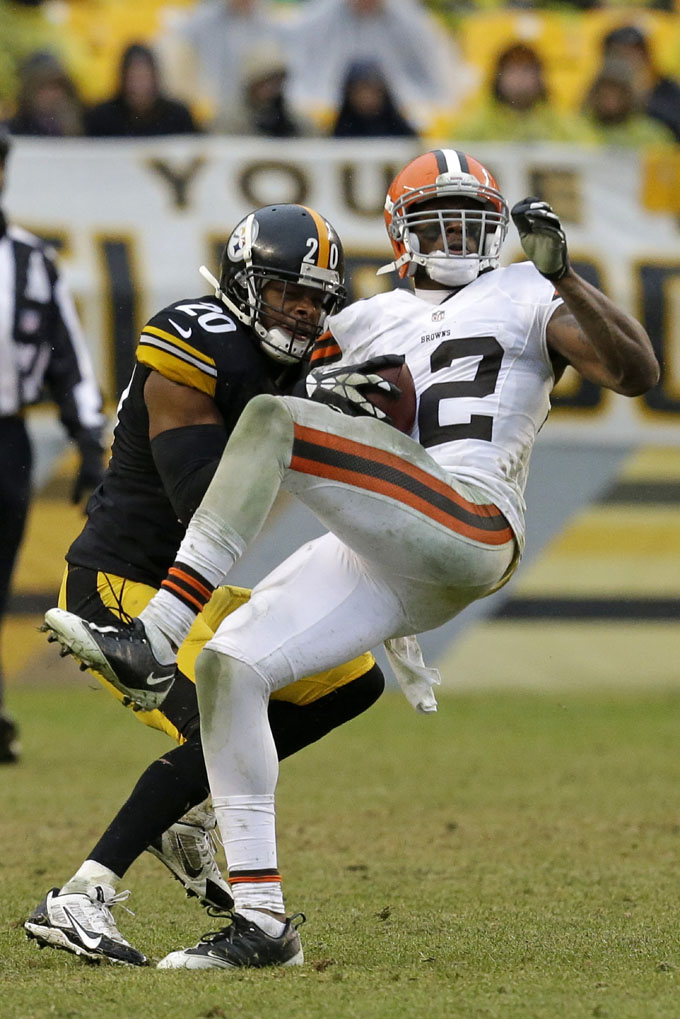 Cleveland Browns wide receiver Josh Gordon (12) is tackled after catching a pass by Pittsburgh Steelers strong safety Will Allen (20) during the second half of an NFL football game in Pittsburgh, Sunday, Dec. 29, 2013. The Steelers won 20-7. (AP Photo/Gene J. Puskar)