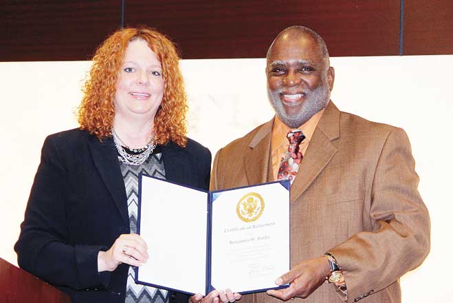 CERTIFICATE OF APPRECIATION—Beth McCoy presents Benjamin W. Butler, who recently retired after 42 years of service in federal government, with a certificate for his service from the Department of Veterans Affairs.    