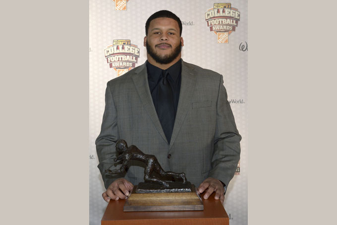 Pittsburgh defensive tackle Aaron Donald poses with the Outland Trophy after winning the honor during the College Football Awards show in Lake Buena Vista, Fla., Dec. 12, 2013. (AP Photo/Phelan M. Ebenhack)