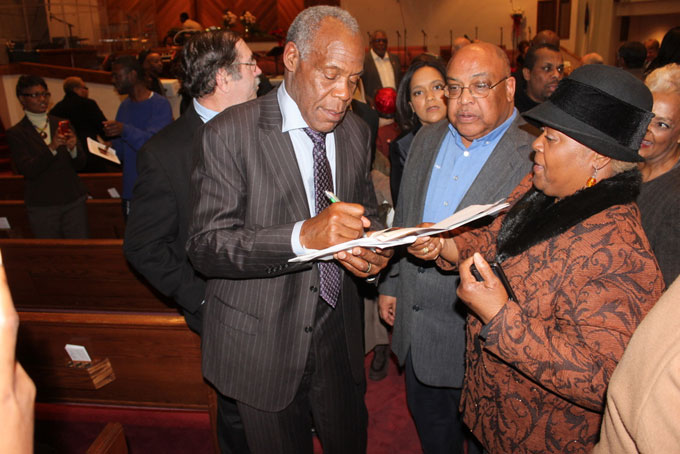 COMMITTED—Actor and international activist for social justice Danny Glover signs autographs after delivering the keynote speech at the Mt. Ararat Baptist Church’s tribute to Nelson Mandela.