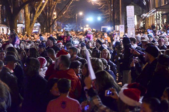 People fill the 400 block of Chestnut Street, Saturday, Dec. 21, 2013, in West Reading, Pa., where thousands of people came out to sing Christmas carols in front of the home of Delaney "Laney" Brown, 8, who is terminally ill with a rare form of leukemia. (AP Photo/Reading Eagle, Ben Hasty)