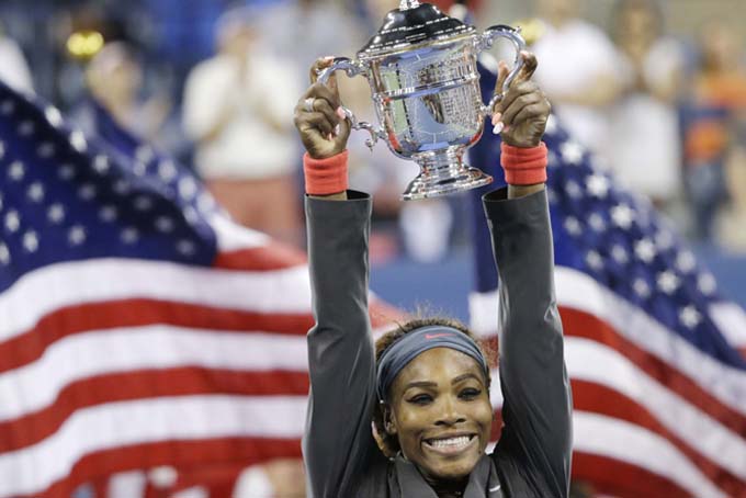 In this Sept. 8, 2013, file photo, Serena Williams, of the United States, holds up the championship trophy after defeating Victoria Azarenka, of Belarus, during the women's singles final of the U.S. Open tennis tournament in New York. (AP Photo/David Goldman, File)