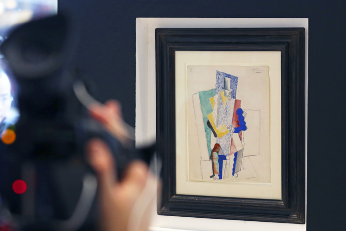 Picasso's 1914 cubist drawing L'homme au Gibus, Man with Opera Hat, is presented at Sotheby's auction house in Paris Thursday Dec. 12, 2013. P Photo/Remy de la Mauviniere)
