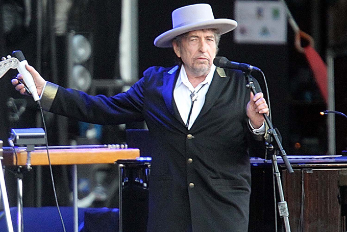 This July 22, 2012 file photo shows U.S. singer-songwriter Bob Dylan performing on stage at "Les Vieilles Charrues" Festival in Carhaix, western France. (AP Photo/David Vincent, file)