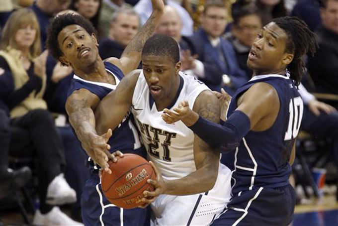 Penn State's Geno Thorpe, left, and Brandon Taylor (10) double-team Pittsburgh's Lamar Patterson (21) in the first half of an NCAA college basketball game on Tuesday, Dec. 3, 2013, in Pittsburgh. (AP Photo/Keith Srakocic)