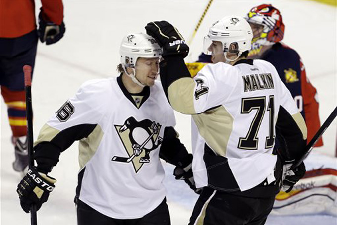 Pittsburgh Penguins left wing Jussi Jokinen, left, is congratulated by center Evgeni Malkin (71) after Jokinen scored a goal during the third period of an NHL hockey game against the Florida Panthers, Saturday, Nov. 30, 2013, in Sunrise, Fla. The Penguins won 5-1. (AP Photo/Lynne Sladky)