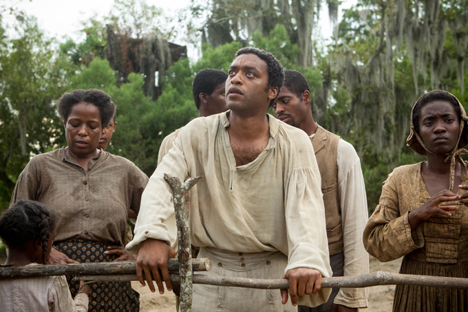 This image released by Fox Searchlight shows Chiwetel Ejiofor, center, in a scene from "12 Years A Slave." The Golden Globes nominations will be announced on Thursday, Dec. 12. (AP Photo/Fox Searchlight, Jaap Buitendijk)   