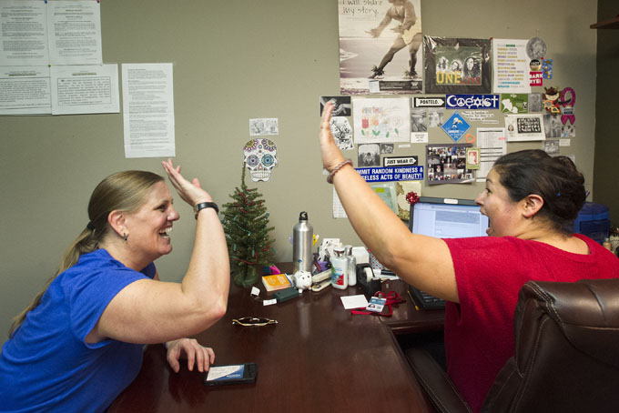In this Dec. 23, 2013 file photo, Lisa Donlea, left, and Susan Roberts, a certified enrollment officer, celebrate after working on Donlea's federal health insurance exchange enrollment online for one hour and 47 minutes in Laguna Beach, Calif. (AP Photo/The Orange County Register, Cindy Yamanaka, File)