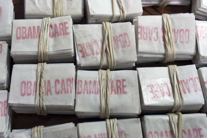 This photo released on Friday, Dec. 20, 2013 by the Massachusetts State Police via Facebook shows some of the 1,250 packets of heroin labeled "Obamacare" and "Kurt Cobain" which state police troopers confiscated during a traffic stop in Hatfield, Mass. (AP Photo/Massachusetts State Police)