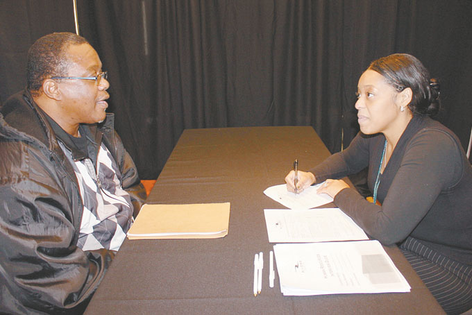 HITTING THE TABLES—Randall Richardson of Carrick interviews with Rivers Casino HR specialist De’Shawn Bell during a Dec. 2 Job Fair for food service positions. (Photo by J.L. Martello)