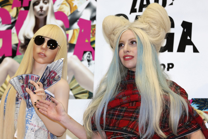 Lady Gaga poses for photographers with her life-sized doll during a press conference to promote her album "ARTPOP" in Tokyo, Sunday, Dec. 1, 2013. (AP Photo/Shizuo Kambayashi)