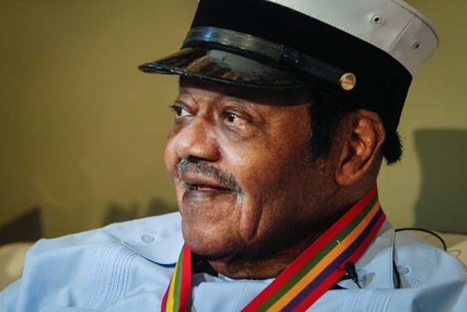 Legendary musician Fats Domino is named "Honorary Grand Marshall" of the Krewe of Orpheus, the star-studded Carnival club that traditionally parades the night before Mardi Gras, Friday, Dec. 20, 2013 in New Orleans. (AP Photo/Doug Parker).