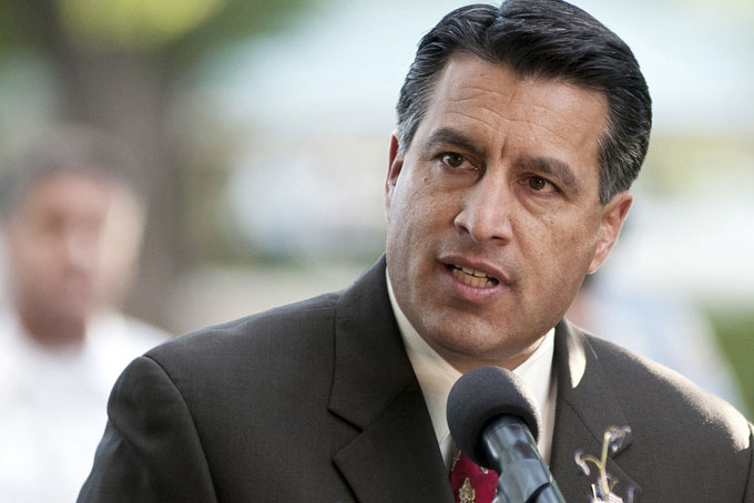 In this Sept. 25, 2011 file photo, Nevada Gov. Brian Sandoval speaks in Reno. Partisan politics are coloring governors’ decisions on whether to expand Medicaid in their states, affecting billions of dollars and thousands of low-income Americans. Whether those people receive Medicaid coverage may have little to do with their need, and much to do with the way their states vote in gubernatorial elections, including primaries. (AP Photo/Kevin Clifford, File)