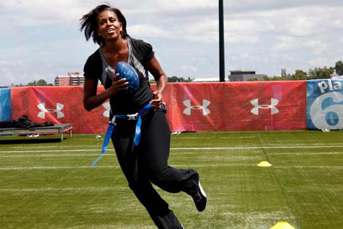 Michelle Obama turns and runs after catching a pass while participating in the Let's Move! Campaign and the NFL's Play 60 Campaign festivities with area youth in New Orleans. (AP Photo/Gerald Herbert, File)