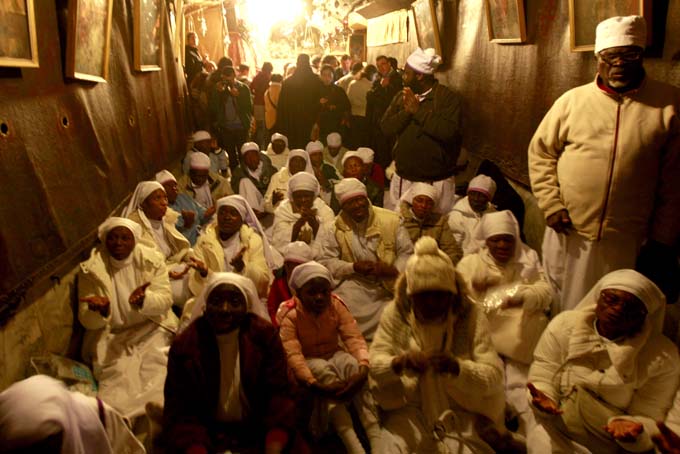 Christian worshippers from Nigeria pray at the Church of Nativity, traditionally believed by Christians to be the birthplace of Jesus Christ, in the West Bank town of Bethlehem on Christmas Eve, Tuesday, Dec. 24, 2013. (AP Photo/Majdi Mohammed)   