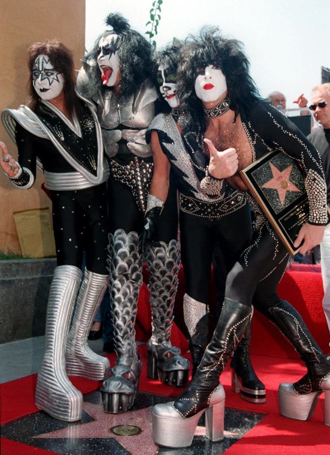 In this Aug. 11, 1999 file photo, Kiss band members, from left, Ace Frehley, Gene Simmons, Peter Criss and Paul Stanley take the ceremonial first step on their new star on the Hollywood Walk of Fame in Los Angeles. (AP Photo/Katie Callan, File)
